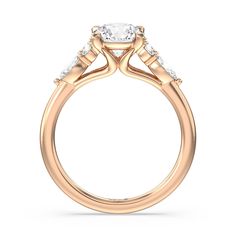 a rose gold engagement ring with three stones on the side