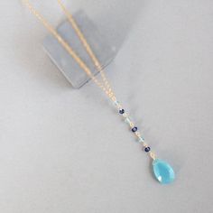 Free shipping on our dainty blue chalcedony y pendant necklace for women. Mixed with iolite and aquamarine gemstone accent stones. Makes an excellent graduation gift, anniversary gift or gift for mom.- Adjustable chain length. Can be extended from 16" up to 18"- Total necklace length, with 2" pendant drop, is 18-20"- Spring ring clasp, - Chain, pendant and clasp are all 14k gold plated over exquisite .925 fine Italian sterling silver. Our unique gold plating technique is tarnish resistant.- Hand Delicate Blue Topaz Jewelry, Blue Gemstone Wedding Necklace, Elegant Blue Crystal Necklace With Gemstone Accents, Delicate Blue Gemstone Jewelry, Elegant Light Blue Necklaces With Natural Stones, Elegant Light Blue Necklace With Natural Stones, Elegant Blue Teardrop Crystal Necklace, Gift Blue Drop Necklace With Natural Stones, Blue Briolette Necklace For Wedding