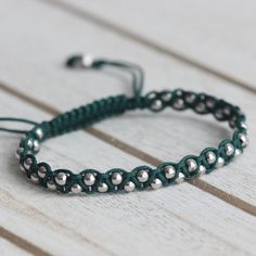 3 mm Rhodium Plated 925 Sterling Silver BeadsAdjustable Length (14 cm to 23 cm)Cord Color: Dark Green Handmade Sterling Silver Braided Bracelet, Green Bracelets With Tiny Beads For Everyday, Handmade Green Beaded Bracelets For Everyday, Green Everyday Bracelets With Tiny Beads, Everyday Green Bracelets With Tiny Beads, Modern Handmade Silver Beaded Bracelets, Elegant Green Round Beads Friendship Bracelets, Minimalist Handmade Silver Beaded Bracelets, Minimalist Green Beaded Bracelets With Tiny Beads