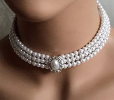 "An elegant versatile three-strand pearl choker comes with a matching pair of stud earrings. This set is a lovely addition to your modern, classic, or vintage-inspired wedding. Bridal jewelry set, Bridal choker necklace earrings, Wedding choker, white Victorian pearl jewelry set, bridesmaid jewelry, choker set, evening jewelry, party jewelry , vintage inspired jewelry * Color : White, Silver, Clear * Theme : Pearl * Necklace Size : 11\" to 14\" adjustable * Decor Size : 1\" L * Bracelet Size : 1 Elegant Round Beads Formal Choker, Elegant Round Beads Choker For Formal Occasions, Elegant Round Beads Choker For Formal Events, Elegant Formal Choker With Round Beads, Elegant Pearl White Choker With Round Beads, Elegant White Round Beads Choker, Formal Pearl Chain Choker With Round Beads, Elegant Choker Jewelry Sets For Party, Delicate Formal Choker Jewelry