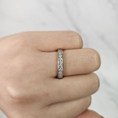 a woman's hand with a diamond ring on it