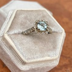 Estate/ Vintage 14KT white gold ring with genuine, rounded, square, cushion-cut aquamarine + diamond halo and accents. Pale, blue color aquamarine with yellow/green undertones. Beautiful stone + well faceted. Size 7 Weight: 3.2 grams Genuine, rounded square cushion cut Aquamarine measures: 6mm x 6mm 1.00+ carat genuine aquamarine .30 CT natural diamonds; SI1/2 clarity (22) diamonds on the shank (12) diamonds on the scroll, filigree halo Not stamped 14K, but fully tested Gold is patina'd and we l Light Blue Diamond Jewelry With Accent Stones, Fine Aquamarine Diamond Ring With Accent Stones, Aquamarine Diamond Ring With Accent Stones, Luxury Light Blue Topaz Wedding Ring, Luxury Light Blue Topaz Ring For Wedding, Luxury Light Blue Rings With Accent Stones, Light Blue Aquamarine Diamond Ring With Center Stone, Light Blue Diamond Ring With Accent Stones, Light Blue Diamond Rings With Accent Stones