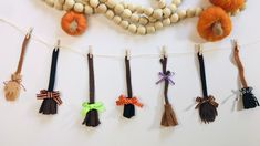 a bunch of beads are hanging on a line with some tassels attached to them