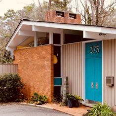 a small brick building with a blue door