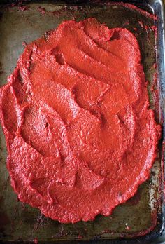 a square pan filled with red cake batter