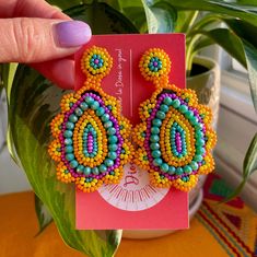 Our Monogem Earrings are a bold a fun statement to add to your fit! These colorful beaded earrings are handcrafted by our artisans in the heart of Mexico Lindo. Colorful Vibrant Earrings With Ear Wire, Artisan Multicolor Beaded Earrings For Gift, Vibrant Colorful Earrings For Gifts, Fun Multicolor Jewelry For Crafting, Handmade Multicolor Beaded Earrings For Party, Handmade Green Beaded Earrings, Colorful Handmade Earrings For Festivals, Handmade Colorful Earrings For Festival, Unique Multicolor Beaded Earrings For Party