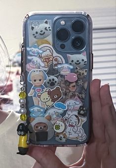 someone is holding up their phone case with many stickers on it in front of the camera