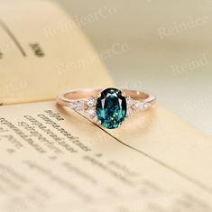 an oval cut blue and white diamond ring sitting on top of a piece of paper