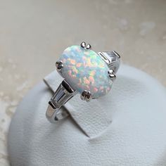 an opal and diamond ring on display