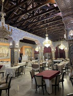 an ornately decorated restaurant with chandeliers and tables