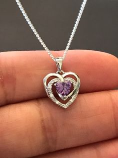 "Sterling Silver Amethyst CZ Heart Necklace Metal: All components are made from solid .925 Sterling Silver Stone: Cubic Zirconia Measurement: pendant is 17mm (0.67\")long including bail and 12mm (0.47\") wide Choose Chain Length Please feel free to Convo me with any questions before purchasing. Please view policy before purchasing You can find other CZ and Birthstone Jewelry in my shop here https://www.etsy.com/shop/LinksAndStones?ref=seller-platform-mcnav&section_id=24399452 Thank You For V Sterling Silver Heart Birthstone Necklace, Purple Double Heart Jewelry For Valentine's Day, Valentine's Day Amethyst Heart Necklace, Sterling Silver Heart Pendant Birthstone Necklace, Sterling Silver Birthstone Necklace With Heart Pendant, Heart-shaped Sterling Silver Birthstone Necklace As Gift For Her, Sterling Silver Open Heart Birthstone Necklace, Purple Heart Necklace For Valentine's Day Anniversary, Silver Sterling Birthstone Necklace With Heart Cut