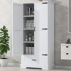 a bathroom with a white cabinet next to a sink