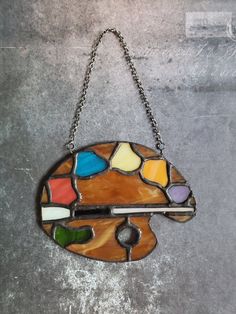 a stained glass piece hanging from a chain