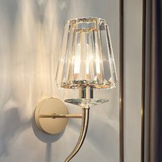 a wall light with a glass shade on it