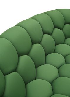 an upholstered green seat cushion is shown in this close - up view,