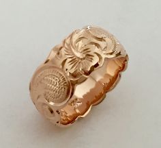 14K Gold Traditional Hawaiian Ring (8mm Barrel)Custom order and Hand made in the Aloha StateHand engraved with Scroll design - Hawaiian Hibiscus Flower and Ocean wave.Made with 14k Rose/Pink gold. Ring width is 8mm.Ring is perfect for people with an active life style, also great gift for anniversary, wedding or any special occasion.*Free inside message engraving. To make the piece more personal, you can add a special message on the inside of the ring, bracelets or pendant. Inside inscription on Hawaiian Rings, Hawaiian Ring, Hawaiian Wedding Rings, Wood Wedding Rings, Wedding Rings Titanium, Pink Gold Ring, Hawaiian Heirloom Jewelry, Old English Letters, Gold Band Wedding Ring