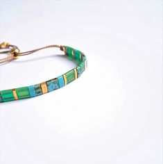 Beautiful colorful adjustable Bracelet, Miyuki Tila beads are hand strung on silk thread, the bracelet opens and closes easily with a gold plated sliding bead. Lovely on its own or combined with your other favorite braclets. Please note this listing is for one bracelet, also as a set available with skinny gemstone bracelet: https://www.etsy.com/listing/973378432/bracelet-set-with-a-tila-bracelet-and S I Z E : Bracelet opens up to 24 cm and nearly always fits, has to be shoven over your hand. If Tile Bracelet, Tila Beads, Bracelet Miyuki, Bracelet Summer, Small Letters, Silk Cord, Cord Bracelets, Silk Thread, Summer Jewelry