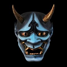 an evil mask with horns on it's head