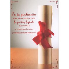 a card with a red ribbon on top of a roll of paper and the words congratulations written in spanish