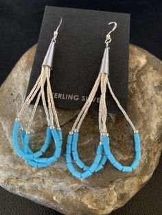 * Beautifully Handmade and original these Blue Turquoise Dangle Liquid Silver Heishi Earrings can add a look of elegance with any casual attire. * They are in Sterling Silver. * Length 2" * Free Gift Pouch with Purchase * Made in USA Please contact seller for any questions and concerns. We hope you have a great experience with us and hope for an awesome review. Southwestern Blue Earrings For Pierced Ears, Southwestern Style Blue Earrings For Pierced Ears, Southwestern Blue Drop Earrings, Southwestern Style Blue Pierced Earrings, Southwestern Style Blue Drop Earrings, Blue Teardrop Dangle Earrings, Blue Southwestern Style Earrings For Gift, Southwestern Blue Earrings For Gift, Blue Nickel-free Long Drop Teardrop Earrings