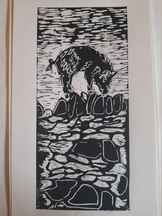 a black and white drawing of a bear on rocks