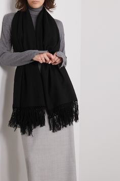 The Row’s ‘Alala’ scarf is made from a wool and cashmere-blend that's cozy, soft and will go with nearly anything. It's minimally designed with fringed edges and has a wide shape that can be knotted at the neck or secured beneath a belt when draped over the shoulders. Wednesday Studios Scarf, Black Tassel Scarf, Black Oversized Scarf, White Cashmere Scarf, Black Wool Scarf, Chanel 5, Hooded Scarf, Fringe Scarf, Womens Cashmere