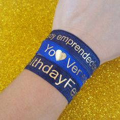 a person wearing a wristband that says, happy empreended love ven birthday tea