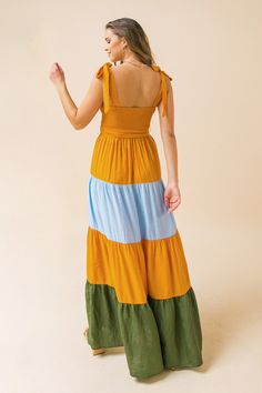 A maxi dress featuring a smocked bodice, tie straps, and a color block tiered skirt Details Self: 80% Rayon, 20% Nylon Contrast: 80% Rayon, 20% Nylon Lining: 100% Polyester Size & Fit - Model is 5`8" And Wearing Size Small - Measurements Taken From Size Small - Approx. Length: 50" Beach Maxi Dress With Tiered Skirt, Fitted Maxi Dress With Tie Back For Casual Wear, Fitted Maxi Dress With Tie Back For Casual Occasions, Summer Flowy Tiered Maxi Dress, Flowy Tiered Skirt Summer Maxi Dress, Chic Maxi Dress With Tie Back, Flowy Summer Maxi Dress With Tiered Skirt, Fitted Tiered Skirt Sundress, Casual Long Dress With Tie Back