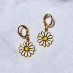 These earrings feature 24k gold plated 14x17mm daisy charms attached to 12mm hoops. Tarnish resistant, lead and nickel free. Matching necklace here. Full necklace and earrings set available here. Cute Gold Jewelry With Flower Charm, Trendy Gold Hoop Earrings With Flower Charm, Trendy Nickel-free Flower-shaped Jewelry, Cute Gold Flower Charm Earrings, Nickel-free Yellow Jewelry For Everyday, Cute Daisy Shaped Jewelry With Flower Charm, Cute Daisy-shaped Jewelry With Flower Charm, Small Hoop Jewelry With Flower Charm For Everyday, Gold Daisy Earrings With Flower Charm