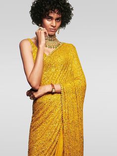 Be an absolute royalty of splendor by adoring this Sabyasachi designer yellow saree in georgette material embellished with all dual sequins work. Accomplished with similar dual sequins choli. The saree surely creates a remarkable look with its sequin motif. This designer surely attract showers of compliment when you will wear it in parties, functions, and weddings. Reception Saree With Sequins In Georgette, Sequin Georgette Saree For Reception, Party Saree With Mirror Work, Semi-stitched, Glamorous Georgette Saree For Party, Designer Pre-draped Sequin Saree For Diwali, Bollywood Style Pre-draped Saree With Mirror Work For Party, Party Semi-stitched Saree With Mirror Work, Chinon Saree For Diwali Party, Chinon Saree For Party