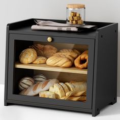 breads and pastries are displayed in a display case