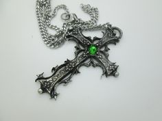 This Gothic cross necklace is an handmade pewter sculpture orned with an Austrian Swarovski or a real gem (My fav is the Black star Diopside, seriously) This gothic necklace is sold with a stainless steel chain of 18'' or 24'', if you would like to have a different length for the chain, you can write the desired length in the private note section when ordering :) This is a Gothic cross of 7cm This gothic cross necklace is a pewter sculpture of my own creation, i create and work the metal by myse Gothic Cross Pendant Jewelry For Halloween, Cross-shaped Halloween Jewelry Gift, Gothic Metal Cross Pendant Jewelry, Gothic Cross Pendant Jewelry, Gothic Cross Jewelry Gift, Gothic Cross Jewelry As Gift, Gothic Cross Jewelry For Gifts, Silver Cross Jewelry For Halloween, Halloween Silver Jewelry With Cross Pendant