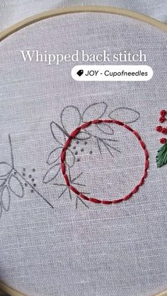 a close up of a embroidery on a piece of cloth with the words whipped back stitch