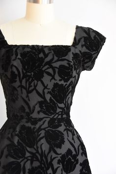 "Stunning vintage 1950s cocktail dress. Flock velvet in floral motif. Square collar and v back. Capped sleeves, darted bust and nipped waist. Semi full skirt with crinoline underneath. Back metal zip closure. State of garment | very good, light overall wear with one small discoloration mark on back of skirt. request additional photos if needed. Measurements ✂--- Best fit | Small Bust | 34\" Shoulders | not specified Shoulder to waist | shy of 15\" Sleeves | 5\" Waist | 25\" Hips | up to 38\" Tot 1950s Satin Dress, Velvet Flower Dress, Vintage Velvet Dress With Fitted Bodice, Vintage Square Neck Evening Dress, Vintage Velvet Cocktail Dress, 50s Goth, Cocktail Dress Floral, Vintage Cocktail Dresses, 1950 Dress