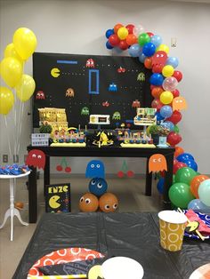 an image of a party setting with balloons and games on the wall in the background