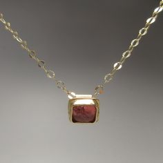 Nothing is as luxurious as solid gold! This 14 karat gold pendant is set with one of my favorite gemstones, a tourmaline cabochon--seriously, they look like candy. The color is pink with a hint of peach which is enhanced by the gold setting. The 18 inch chain and handmade clasp are solid 14 karat gold. 14 karat gold is hypoallergenic and durable enough for everyday wear. For discounts on the same items listed in my Etsy shop, check out idlegauds.com. Tourmaline Pendant, Tourmaline Necklace, Pink Tourmaline, Gold Pendant, Tourmaline, Solid Gold, Favorite Jewelry, Jewelry Necklace Pendant, Handmade Items