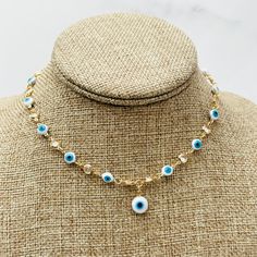 This elegant choker necklace features shiny stones and a Turkish eye--symbolizing protection from evil. This Evil Eye choker is the perfect accessory to complete your outfit. Its neutral color palette and Turkish eye charms make it a stunning yet versatile option. Material: 18k Gold Filled -16-inch necklace with two extra extensions! - Evil Eye Width: 5.5mm  -Perfect for all time. -High-quality Choker.  FAST & FREE SHIPPING! Our handmade products are rated very highly by our customers. We work h Gold Necklaces With Evil Eye For Festival, White Evil Eye Jewelry For Festivals, Symbolic Evil Eye Jewelry For Festival, Gold Evil Eye Necklaces For Festivals, Gold Evil Eye Necklace For Festival, Spiritual Evil Eye Necklaces For Festival, Spiritual Choker Necklace With Adjustable Chain, Evil Eye Choker Necklace As Gift, Traditional Gold Evil Eye Necklace