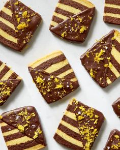 several pieces of cake with chocolate frosting and yellow sprinkles