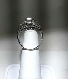 A wonderful Victorian band with great filigree detail. The center stone measures out at .80 ct and has a clarity of SI1 and G color. There is a small natural crystal on the girdle. On either side are 2 @.05ct diamonds set in diamond shape gold. The band weighs 2.5 grams and is is excellent condition. It measures 8.5mm across the top. Antique Brilliant Cut Diamond White Ring, Antique Brilliant Cut Diamond White Diamond Ring, Antique Diamond White Diamond Ring With Brilliant Cut, Classic Jewelry With Diamond Accents And Round Cut, Classic Engraved Ring With Center Stone, Formal Jewelry With Vvs Clarity Round Cut, Formal Round Cut Jewelry With Diamond Accents, Emerald Cut Platinum Wedding Ring In Diamond White, Elegant Oval Engraved Ring With Intricate Design