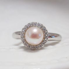 Material: solid sterling silver, Rhodium plated, cubic zircon Required pearl:6-7mm (the pearl in the picture is 6mm round pearl) Size: adjustable 0.9mm pin for half drilled pearl or bead The listed price is only for the setting, without any pearl or bead DISCOUNTS ON LARGE ORDERS Get 10% off for order $50-$99 Get 15% off for order $99-$199 Get 20% off for order $200-$399 Get 25%off for order $400 and more For order over 300 dollars will be shipped by FEDEX or TNT for free. All the discounts will Anniversary Pearl Ring With Halo Setting And Cubic Zirconia, Pearl Promise Ring With Halo Setting, Anniversary Pearl Ring With Halo Setting, White Gold Pearl Ring With Halo Setting For Promise, Cubic Zirconia Pearl Ring With Halo Setting, Silver Pearl Ring With Prong Setting, Pearl Ring With Halo Setting And Cubic Zirconia, Silver Diamond Pearl Ring With Halo Setting, Silver Solitaire Pearl Ring