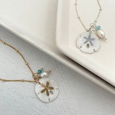 Legend has it that finding a sand dollar during a beach stroll is considered a lucky omen. So take a little bit of the beach and good luck with you wherever you go with our gorgeous Sand Dollar Charm Necklace. Features our most loved satellite chain, freshwater pearl, and blue zircon accents. Freshwater Baroque Pearl size: 6 to 8mm Blue Zircon roundel gemstone 4mm 14kt gold fill or sterling silver round beads 2mm 14kt gold fill or sterling silver satellite chain Real sand dollars are preserved a Sand Dollars, Charm Necklace Silver, Pearl Choker Necklace, Sand Dollar, Blue Zircon, Pearl Choker, Pearl Size, Baroque Pearls, 14kt Gold