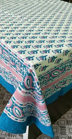 Indian Square Table Cover, Table Cloths, Yoga Mat Sheet and Picnic Purpose sheet Mostly use full in home decor and give a better luxury. 100% cotton fabric ensures skin-friendliness, easy wash-ability and color-fastness. The world has known fewer other pleasures to match the pampering comfort of a welcoming Table at home. A fine fusion of both comfort and design- this vibrant.

Square Table cloth Floral Print design in vegetable dye Blue-Pink combination. Dining Table Cover, Block Table, Square Dining Table, Floral Print Design, Square Table, Square Dining Tables, Table Cloths, Border Pattern, Square Tables