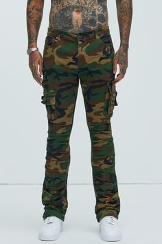 Available In Camouflage. Flared Fit Zip Fly Button Closure 5 Pocket Detail Cargo Pockets With Strap Detail Ruched Detail 98% Cotton 2% Spandex Imported | Mens Step In Ruched Slim Flare Cargo Pants in Camouflage size 42 by Fashion Nova Military Style Fitted Bottoms For Streetwear, Fitted Military Style Bottoms For Streetwear, Military Camouflage Jeans With Cargo Pockets, Fitted Combat Bottoms With Cargo Pockets, Fitted Military Style Pants For Streetwear, Stretch Camouflage Bottoms With Pockets, Stretch Military Camouflage Bottoms, Military Camouflage Cargo Jeans, Military Cargo Style Camouflage Jeans