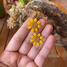 the tiny yellow flowers are being held in someone's hand