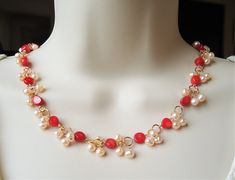 You really can't go wrong with this classic pearl necklace. It is so elegant and versatile, perfect for all seasons. This necklace combines natural red coral with small clusters of freshwater pearls. Natural coral will have some dark spots and slight imperfection in size and colors. Great for the office or every-day wear. This piece is finished with a simple lobster claw closure. Necklace measures 18" in length, with 2 inches extension. This elegant necklace is unique, feminine and eye-catching, Red Pearl Necklace With Pearl Charm As Gift, Red Pearl Necklace With Charm As Gift, Elegant Coral Pearl Necklace With Round Beads, Red Pearl Beaded Necklaces With Pearl Chain, Red Pearl Necklace With Round Beads, Elegant Coral Beaded Necklaces For Gift, Elegant Coral Beaded Necklace For Gift, Elegant Red Pearl Necklace Gift, Red Pearl Necklace With Pearl Drop