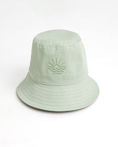 Sun, sea, and 100% cotton Nothing says cool and breezy like a bucket hat. It's snug, soft, and gives you that easy-going surfer dude look - all whiles shielding you from the sun! All our hats are 100% cotton, Sage Green in color, and embroidered with a sun and sea logo - letting you enjoy the seaside sun in style! Jojo bucket hat in Sage Green  Wider brims provide more protection from the UV lights 100% cotton gabardine Spot clean / cold hand wash Suitable for 55-58 cm Comfortable Adjustable Beach Hats, Cotton Bucket Hat With Uv Protection For Vacation, Comfortable Summer Hats With Curved Brim, Summer Hat With Curved Brim, Lightweight Cotton Summer Hats, Comfortable Summer Hat With Curved Brim, Comfortable Curved Brim Summer Hat, Cotton Bucket Hat For Beach Season, One Size, Cotton Bucket Hat For Beach Season