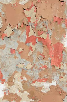 an old peeling paint on the side of a building with red and brown spots all over it