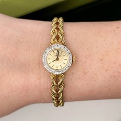 "14kt yellow gold ladies vintage Omega watch with 24 round single cut diamonds set around the bezel and a double rope band. The movement is a wind-up mechanism that is currently working. ALL ORIGINAL PARTS Watch measures: 7\" Length 1/4\" Band width 5/8\" Case" Yellow Gold Diamond Watch With Round Dial For Anniversary, Anniversary Yellow Gold Diamond Watch With Round Dial, Anniversary Diamond Watch In Yellow Gold, Anniversary Yellow Gold Diamond Watch With Accents, Classic Gold Diamond Watch With Single Cut Diamonds, Timeless Gold Watches With Single Cut Diamonds, Yellow Gold Diamond Watch With Diamond Hour Markers, Gold Diamond Watch With Accents For Anniversary, Yellow Gold Diamond Watch With Round Face