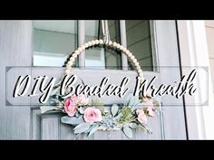 a door with a wreath hanging from it's side and the words diy beaded wreath above it