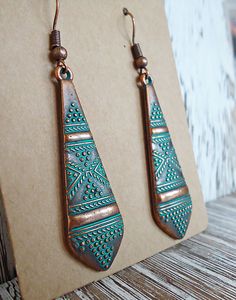 These earrings are made from a metal alloy with a copper finish and a blue/green patina. They dangle approximately 1.75" from coordinating copper colored earwire. Green Bohemian Earrings With Patina, Copper Teardrop Earrings With Patina, Bohemian Bronze Earrings With Patina, Green Copper Earrings With Patina, Copper Dangle Earrings With Patina, Antique Finish Copper Dangle Earrings, Vintage Patina Earrings, Bohemian Copper Earrings With Patina, Bohemian Green Patina Earrings